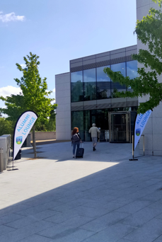 Exterior of UCD Alumni Lounge with teardrop flags outside