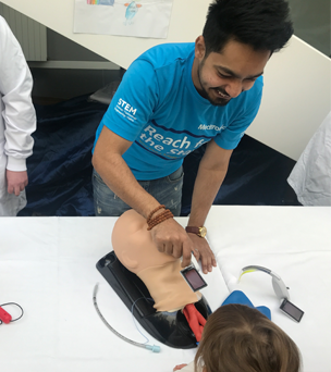 Person conducting demonstration with a dummy head